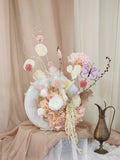Handcrafted donut vase with blush preserved flower arrangement, full view