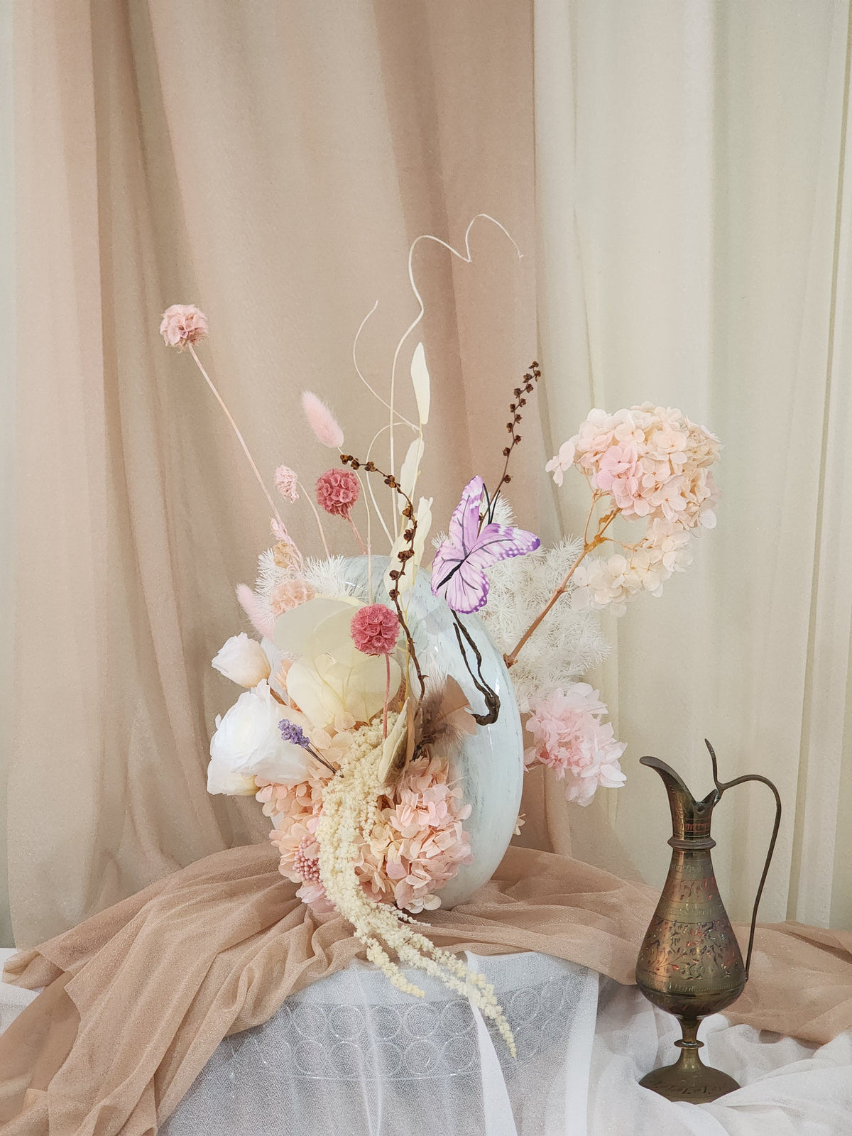 Detail of donut vase showing preserved roses, hydrangeas and dried botanicals