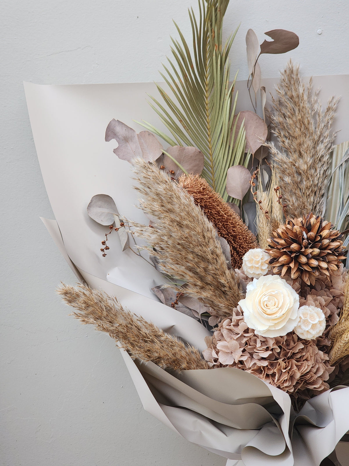 Close-up of dried bouquet showing hydrangeas, roses and banksia