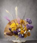 Preserved flower vase arrangement with yellow and purple hydrangeas, pampas grass and palm fan