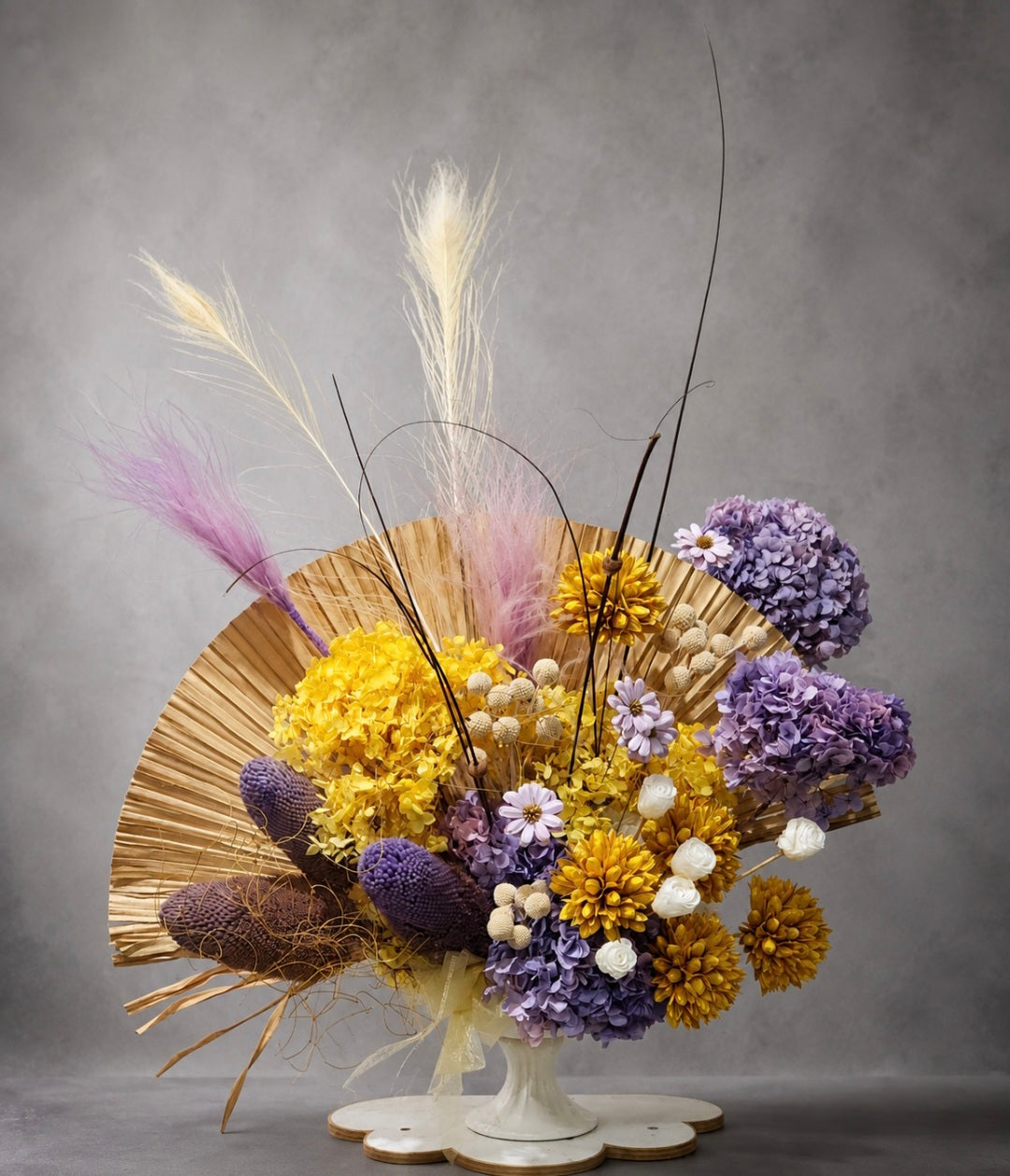 Preserved flower vase arrangement with yellow and purple hydrangeas, pampas grass and palm fan